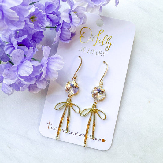 O’Lolly “Blakely” Earrings- Clear Stone w/Gold Bow Dangle: Silver
