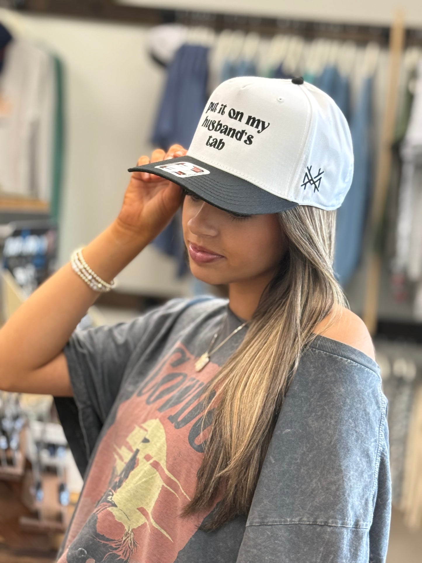 MHC Put it on my Husband's Tab Trucker Hat: Black/ White Otto