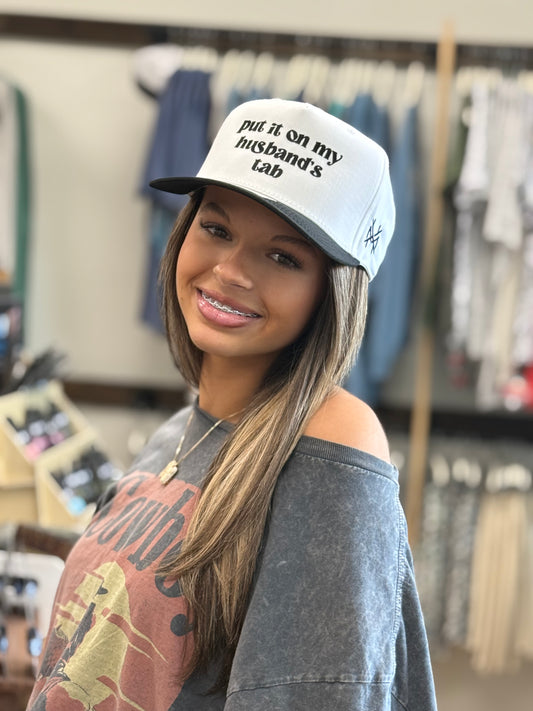 MHC Put it on my Husband's Tab Trucker Hat: Black/ White Otto