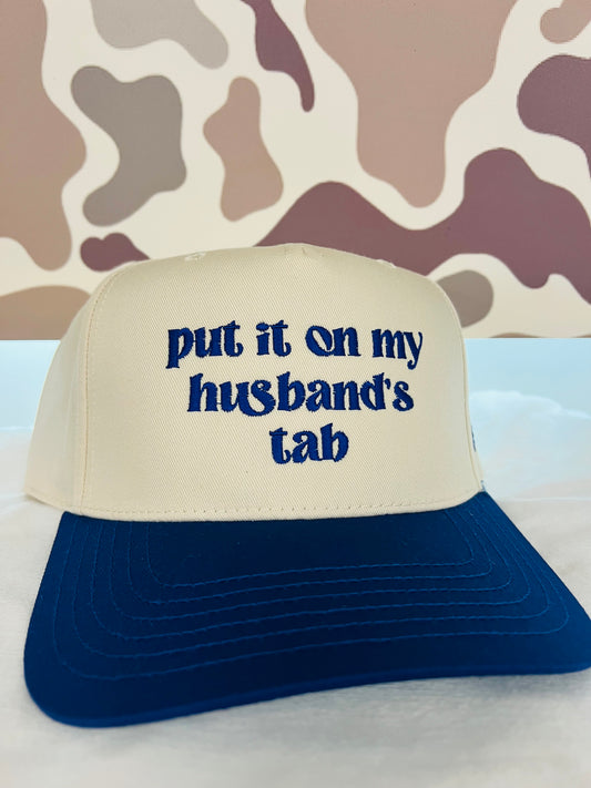 MHC Put it on my Husband's Tab Trucker Hat: Royal/Natural Otto