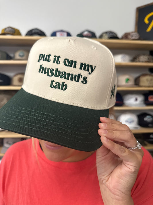 MHC Put it on my Husband's Tab Trucker Hat: Green/Natural Otto