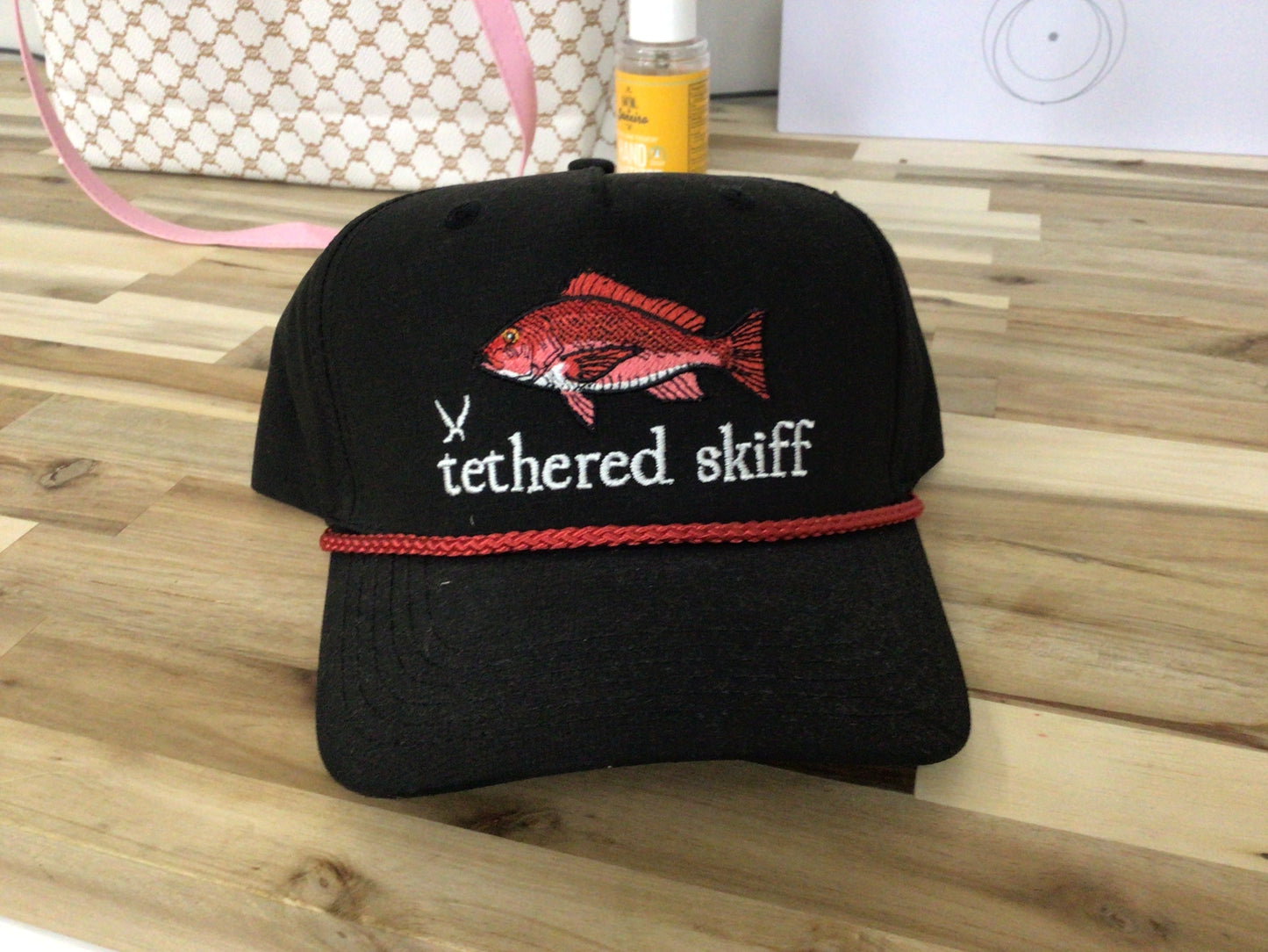 Tethered Skiff snapper fish- black red rope